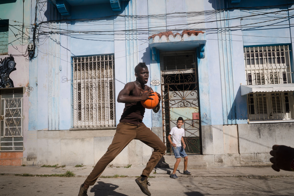 black cuban boy jumping with a basket ball , picture taken by louis alarcon in a photography tour