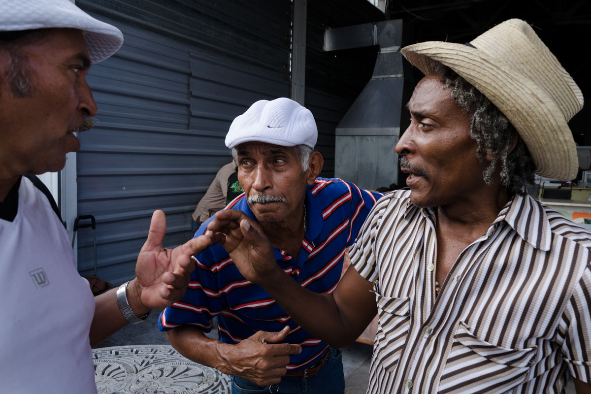 three cubans speaking really close, photo taken in a photo tour by Louis Alarcon