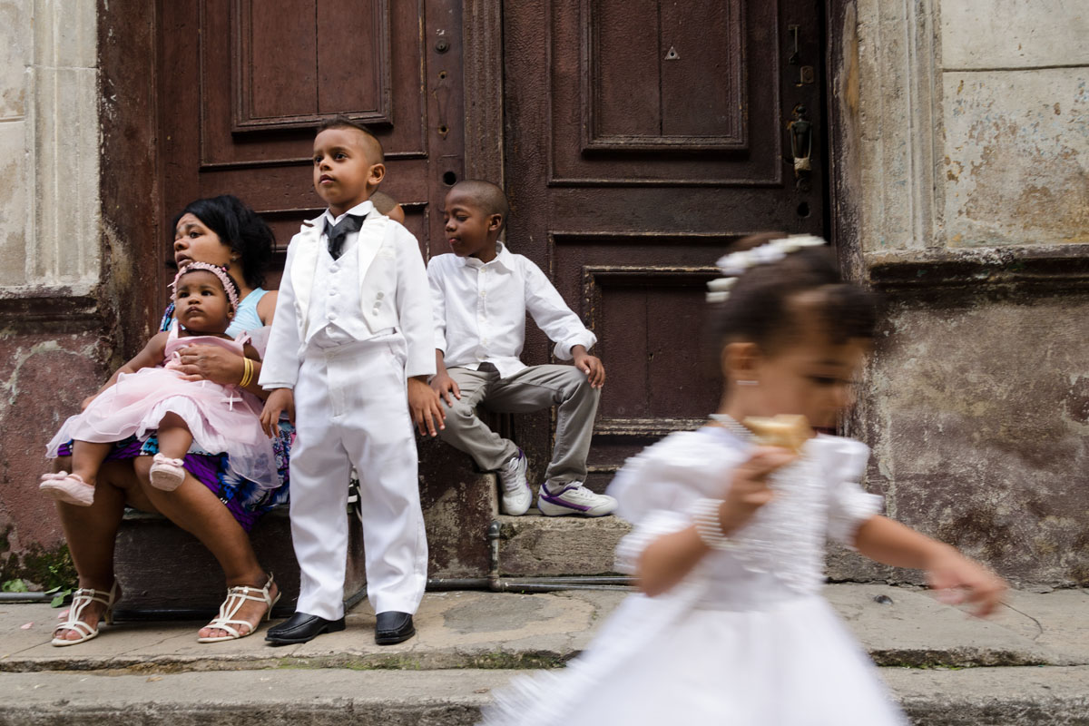 cuban children dress in white in a wedding in havana, street photography style in havana, cuba