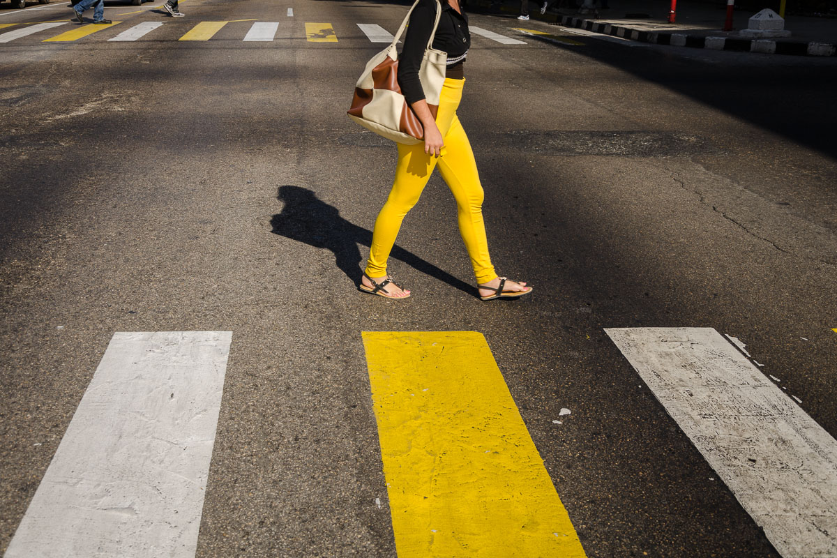 yellow cuban girl crossing a street in havana