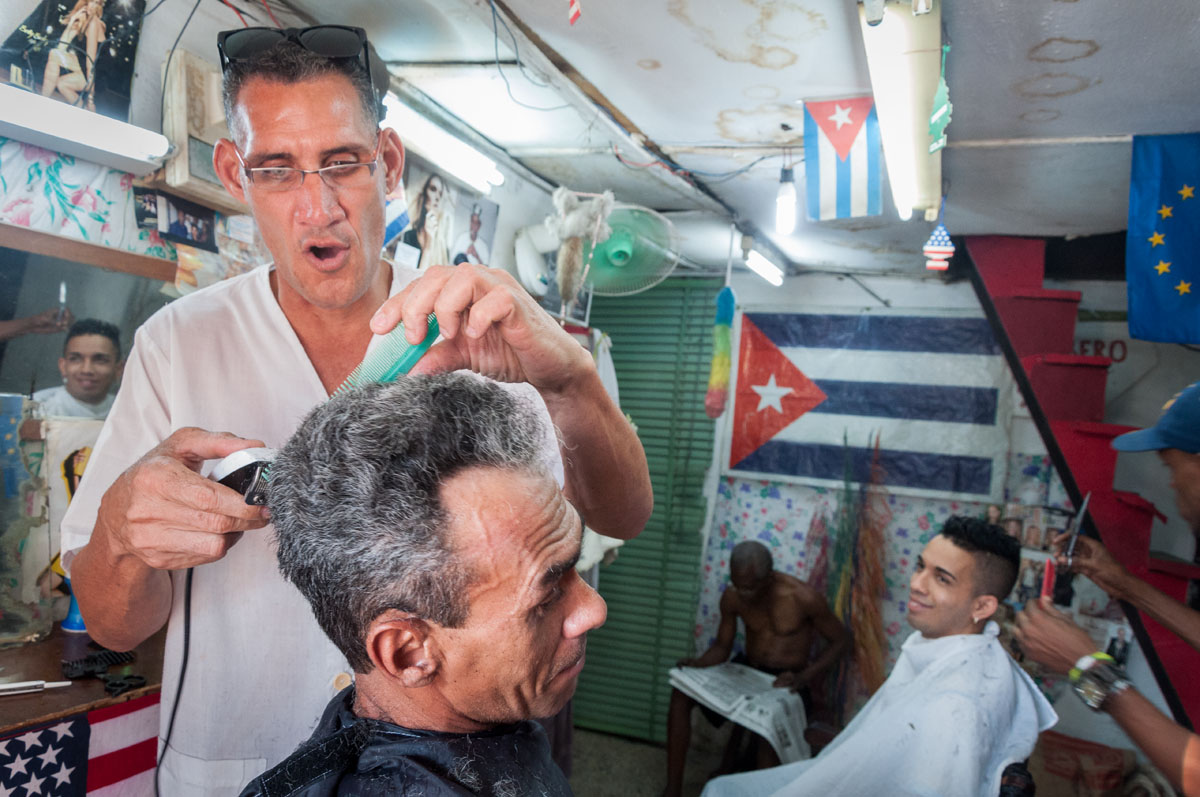 hair cutting four man  in a photo shoot in our cuba photo tours