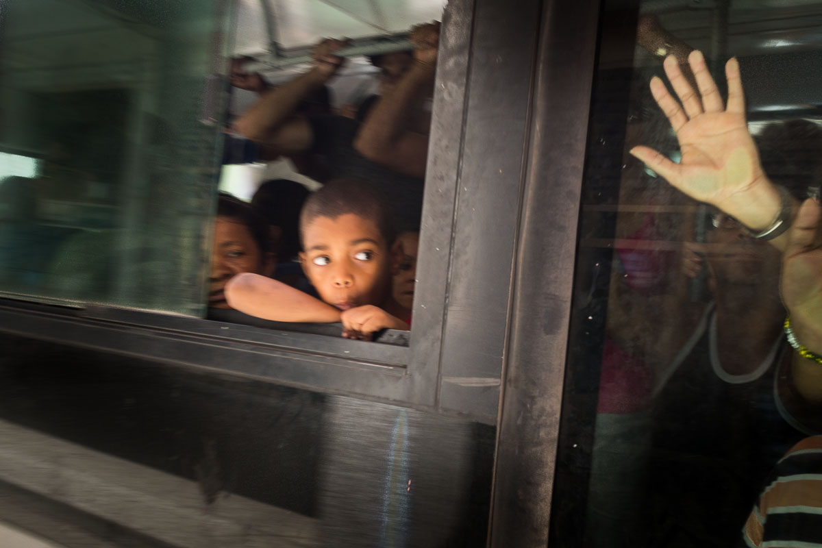 children in a bus through the window in a  photo tour in cuba