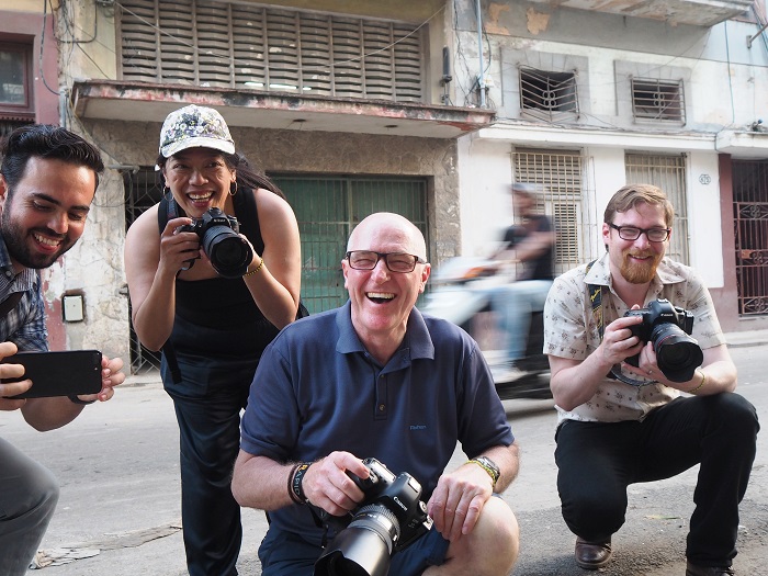 photographers smiling practising street photography in Havana streets with cuban photographer louis alarcon