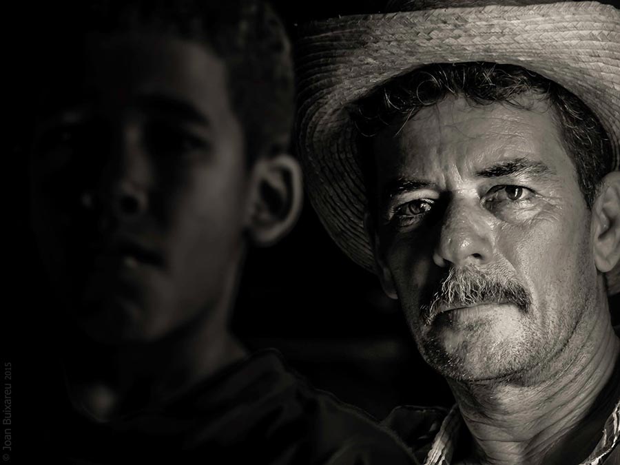 Father and son in a portrait black and white in vinales the country side of cuba