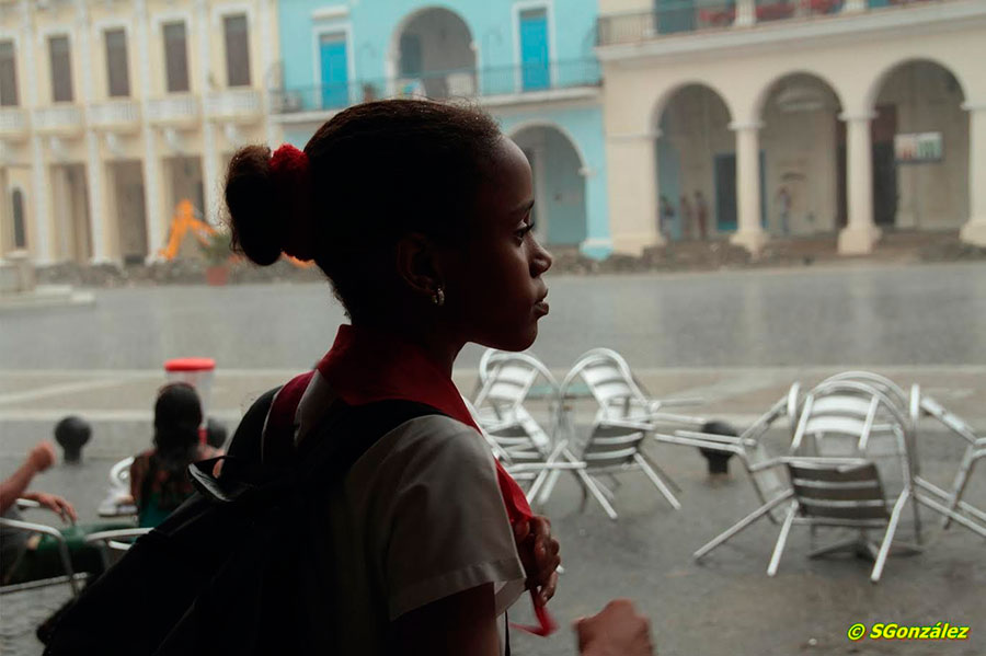 school girl in a rainy day waiting