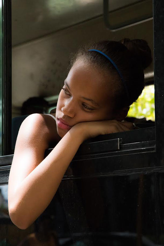 little cuban girl resting in the window of a bus in my city photo tour in havana