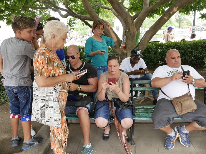 cubans connected to internet in a wifi area in a park . by Louis Alarcon