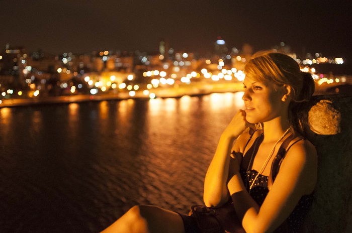 portrait in havana at night with the city as background